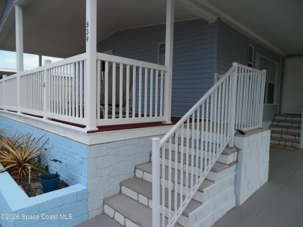 a view of a balcony with chairs