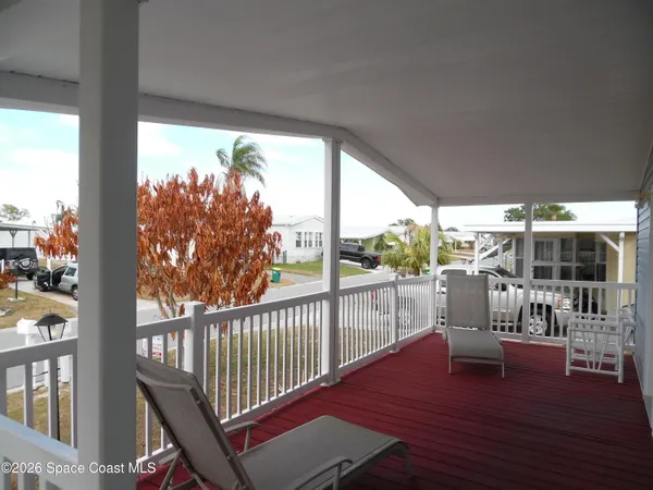 a view of a balcony with wooden floor