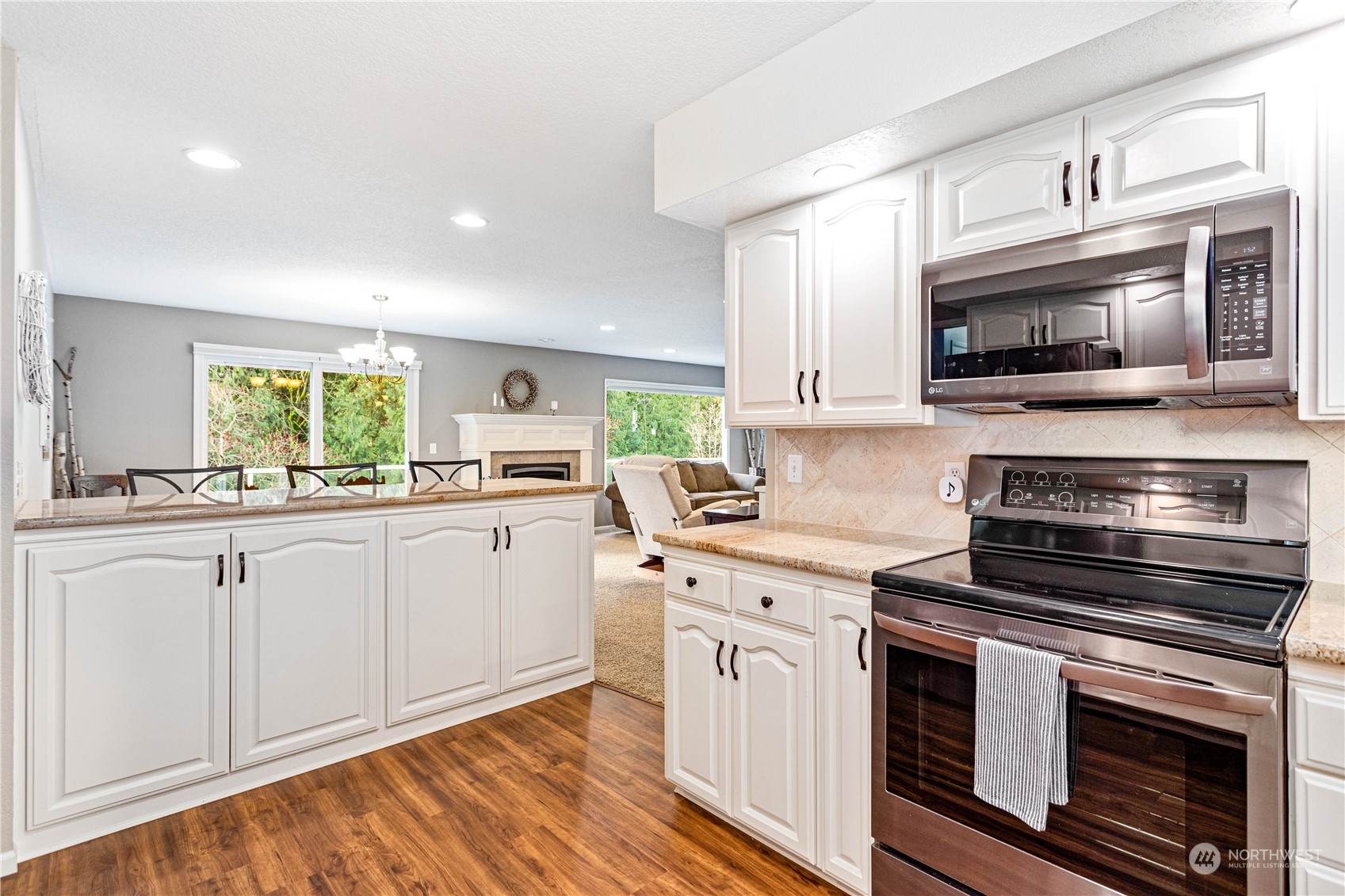 8669 Berthusen Road Lynden, WA 98264 - Photo 13 of 39 a kitchen with a stove and a microwave