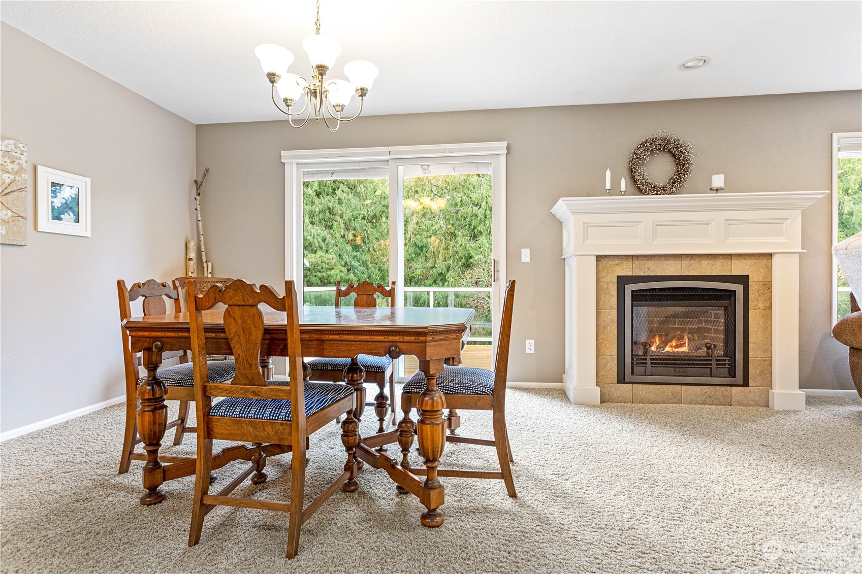 8669 Berthusen Road Lynden, WA 98264 - Photo 7 of 39 a dining room with furniture a fireplace and a chandelier
