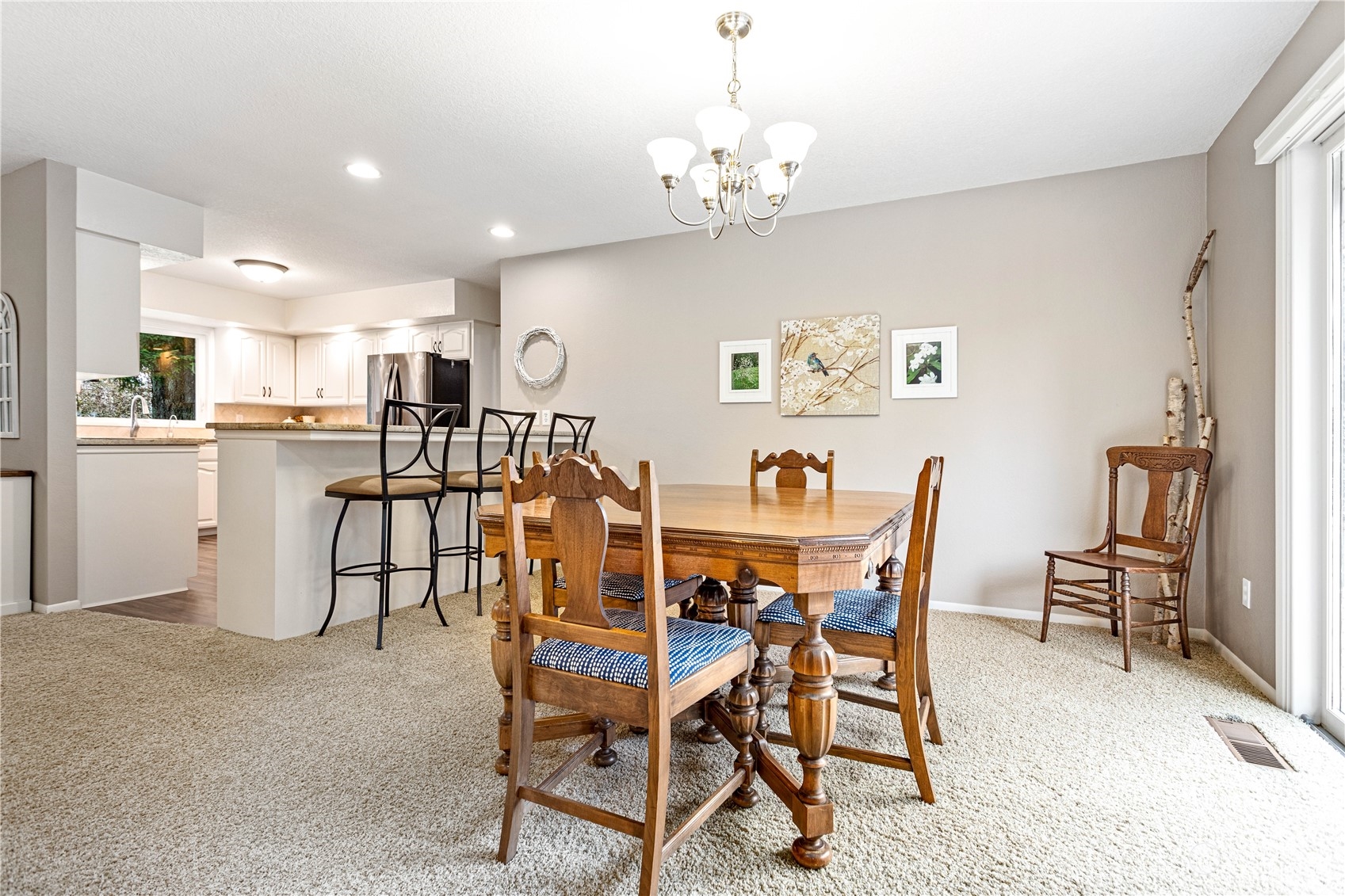 8669 Berthusen Road Lynden, WA 98264 - Photo 8 of 39 a view of a dining room with furniture and a chandelier