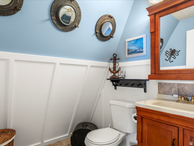 371 Lewis Loop, Unit 29 Fish Haven, ID 83287 - Photo 31 of 40 Bathroom vanity featuring a wood-finish cabinet, integrated sink, and brass-tone fixtures