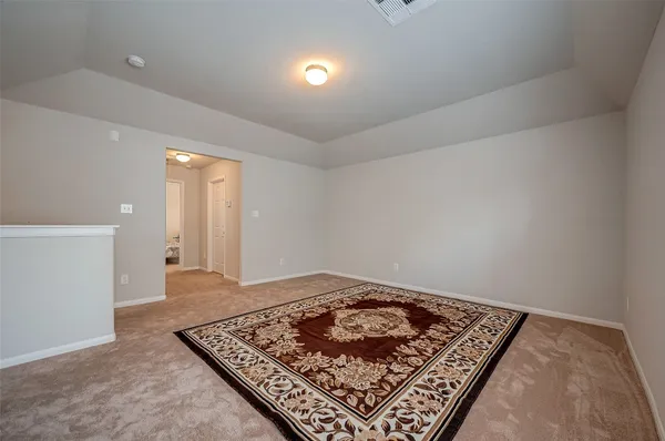 a view of an empty room and kitchen space