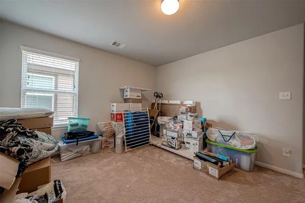 a bedroom with furniture and a window