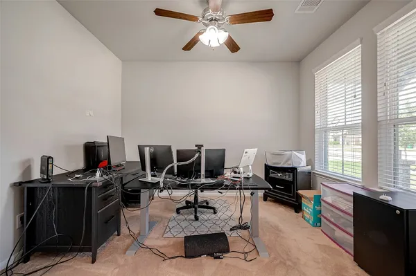 a living room with furniture a flat screen tv and a window
