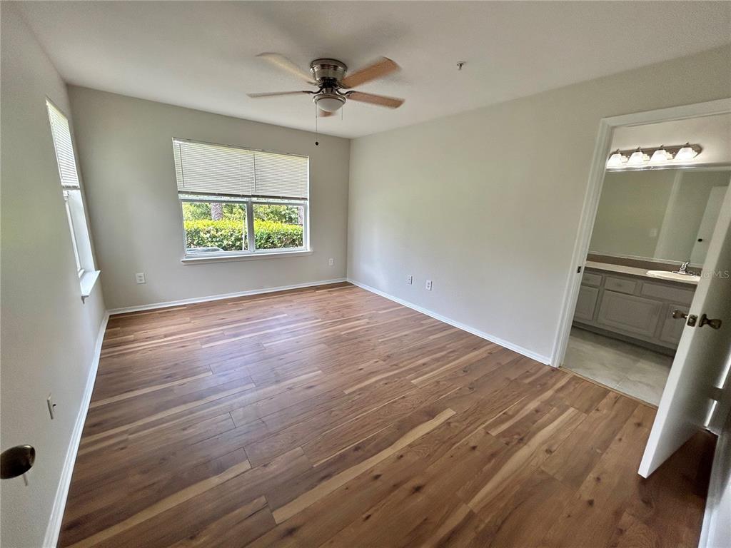 413 Summit Ridge Place, Unit 115 Longwood, FL 32779 - Photo 14 of 44 a view of an empty room with a window and wooden floor