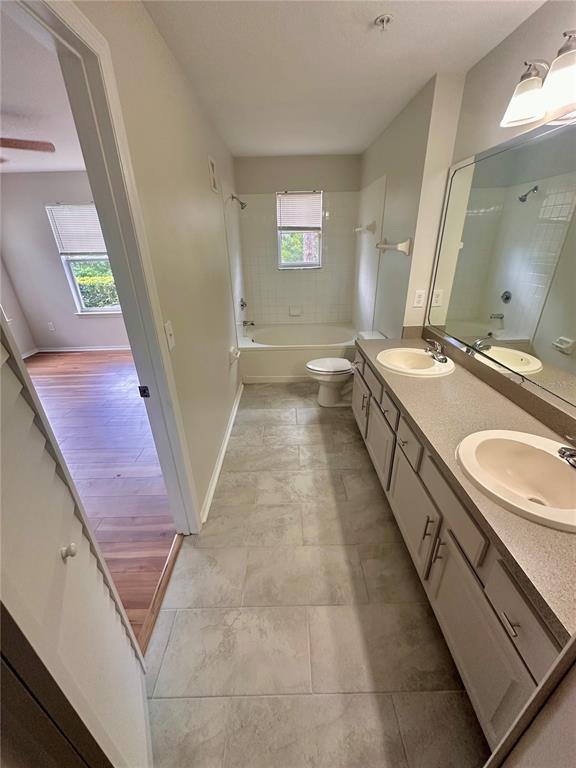 413 Summit Ridge Place, Unit 115 Longwood, FL 32779 - Photo 16 of 44 a bathroom with a granite countertop sink a mirror and a bathtub