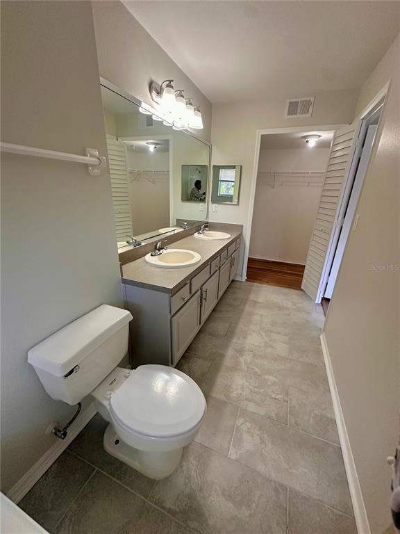 413 Summit Ridge Place, Unit 115 Longwood, FL 32779 - Photo 17 of 44 a bathroom with a toilet sink and mirror