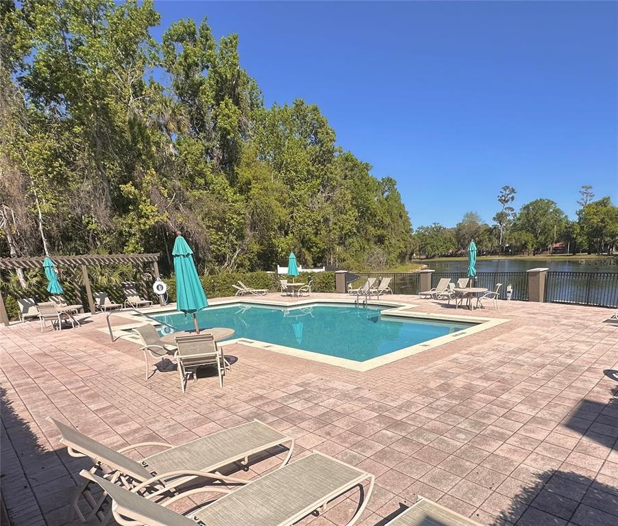 413 Summit Ridge Place, Unit 115 Longwood, FL 32779 - Photo 28 of 44 a view of a swimming pool with an outdoor space and seating area