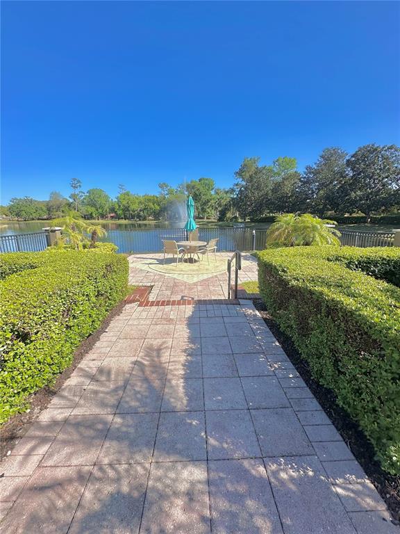413 Summit Ridge Place, Unit 115 Longwood, FL 32779 - Photo 31 of 44 a view of a lake with a yard