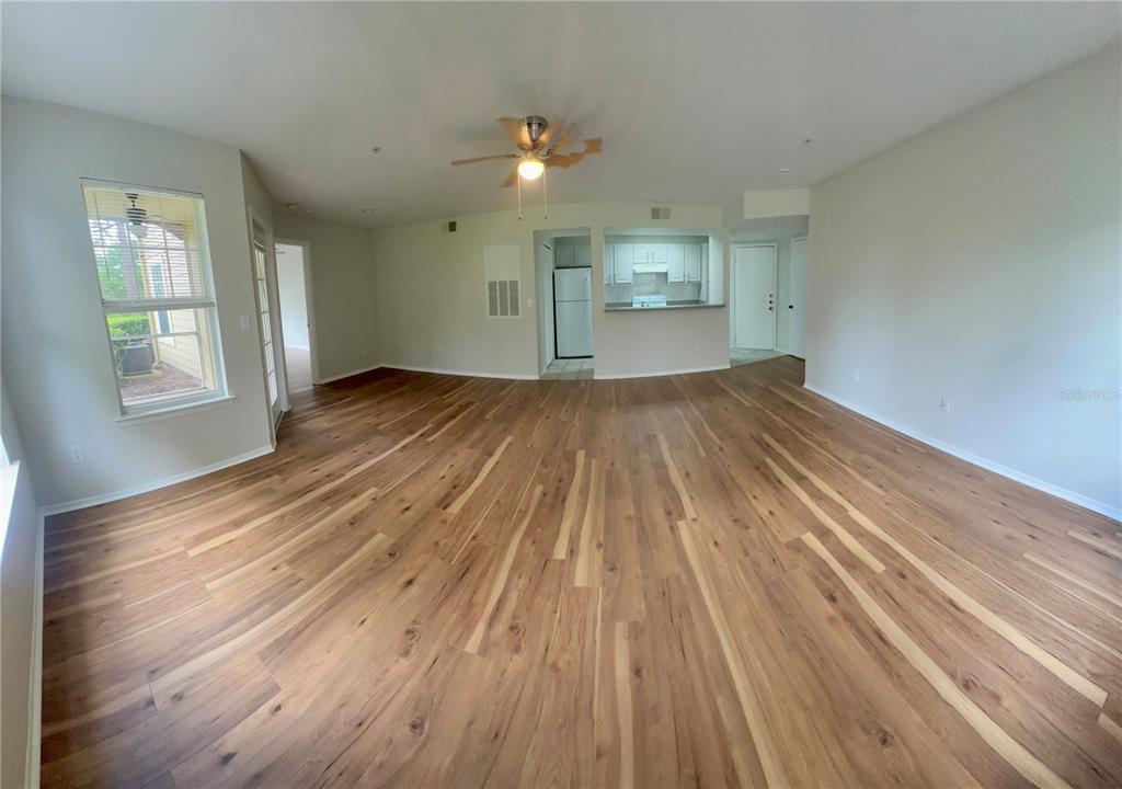 413 Summit Ridge Place, Unit 115 Longwood, FL 32779 - Photo 9 of 44 a view of empty room with wooden floor and fan