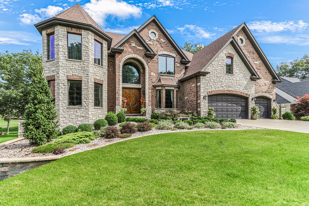 a front view of a house with a yard and garage