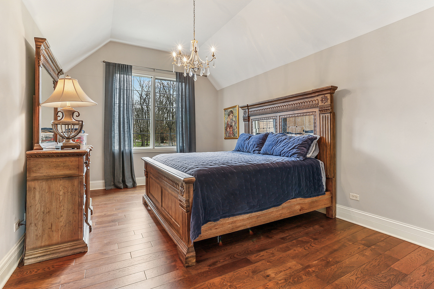 14151 131st Street Lemont, IL 60439 - Photo 51 of 62 a spacious bedroom with a bed and a chandelier