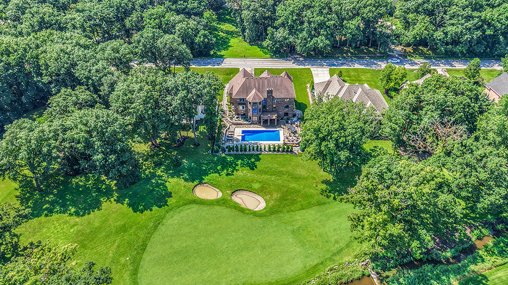 14151 131st Street Lemont, IL 60439 - Photo 8 of 62 an aerial view of a house with swimming pool and garden