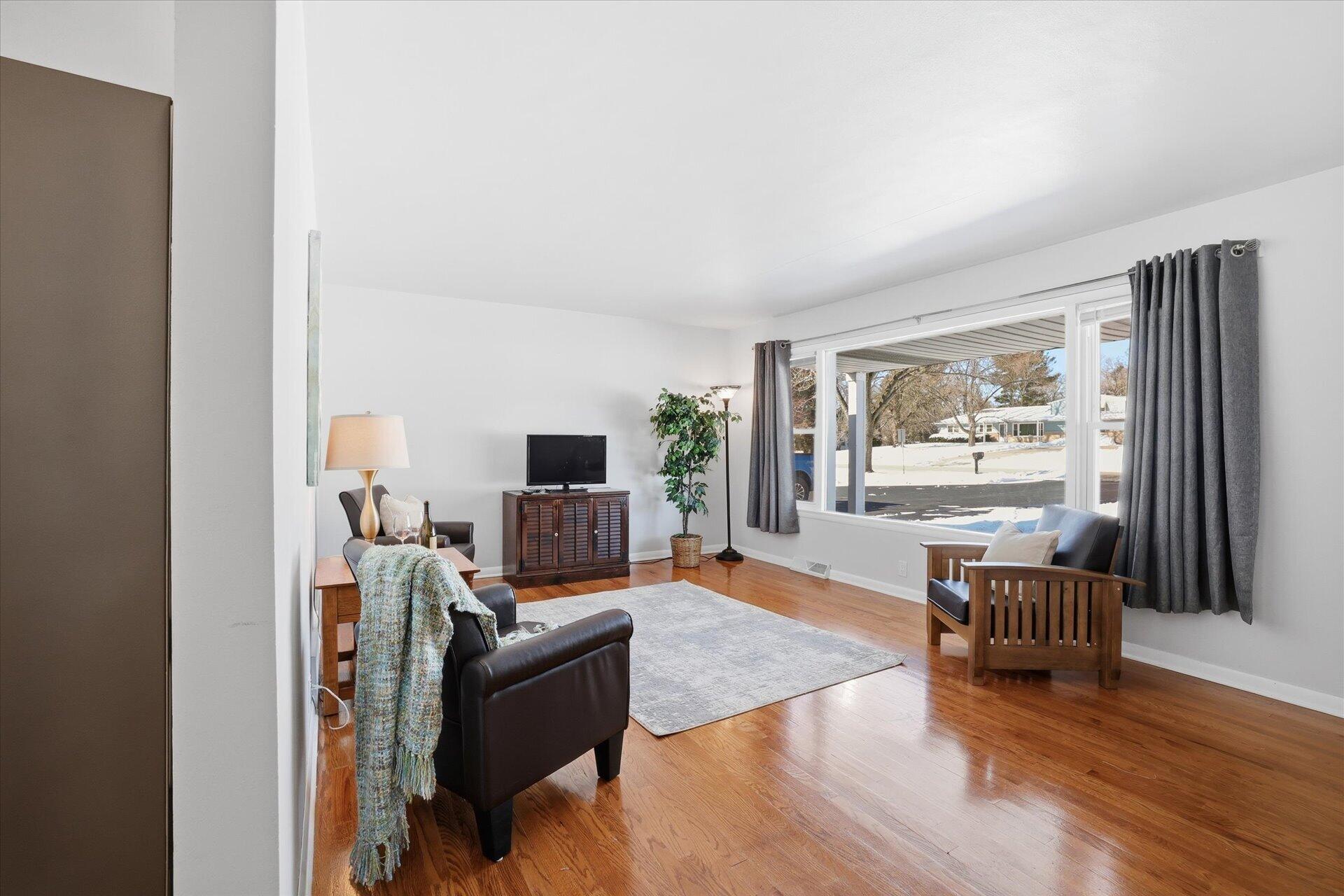 2330 South Sunny Slope Road New Berlin, WI 53151 - Photo 12 of 28 Light Filled Living RM w/Hardwood Floors