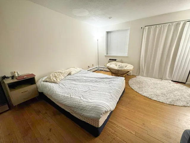 a bedroom with bed and window