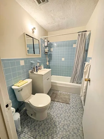 a bathroom with a toilet a sink and a shower