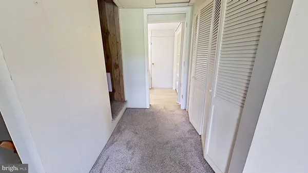 a view of a hallway with a white door
