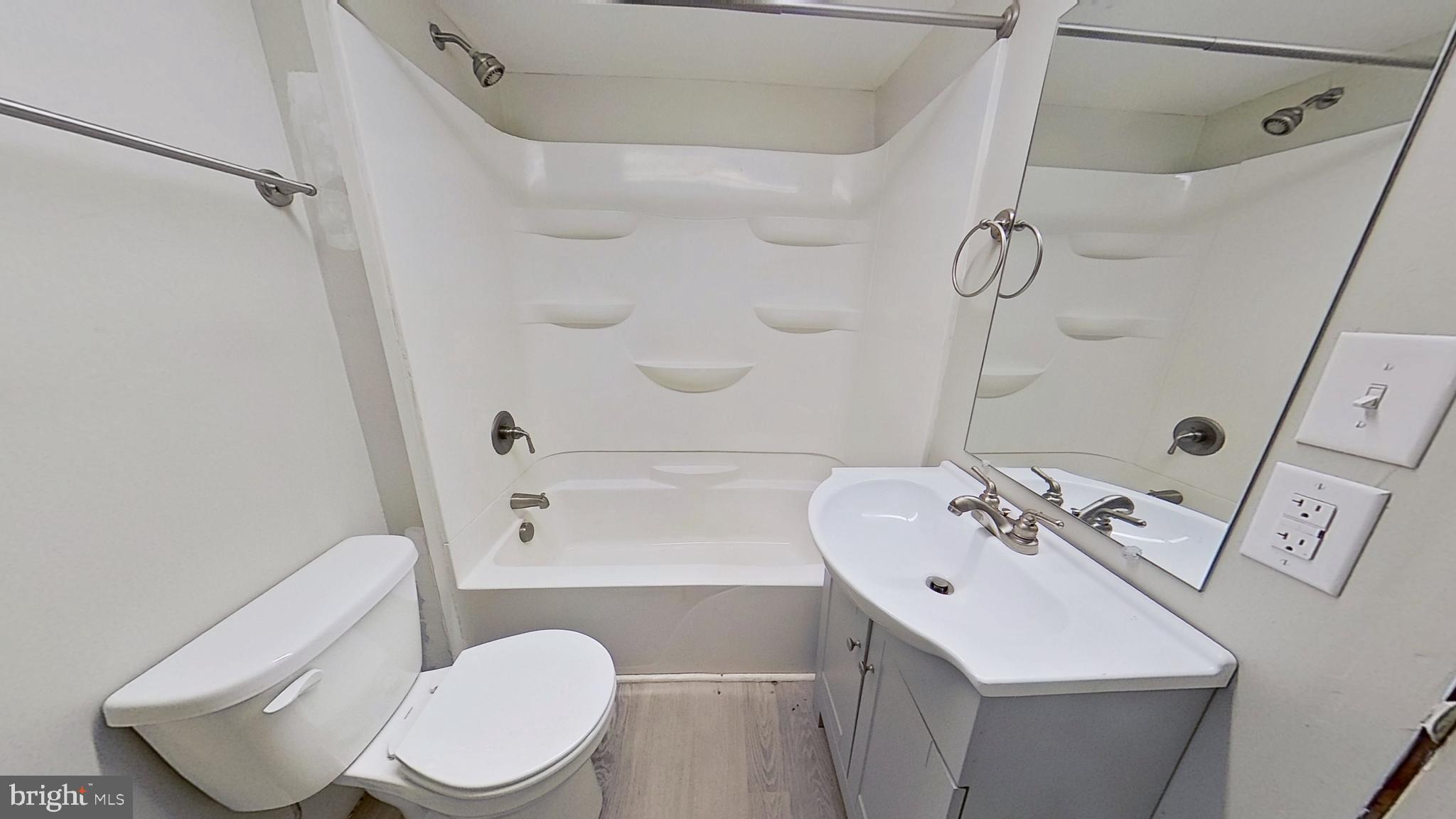 18 East Main Street, Unit B New Freedom, PA 17349 - Photo 10 of 11 a bathroom with a sink a toilet and shower