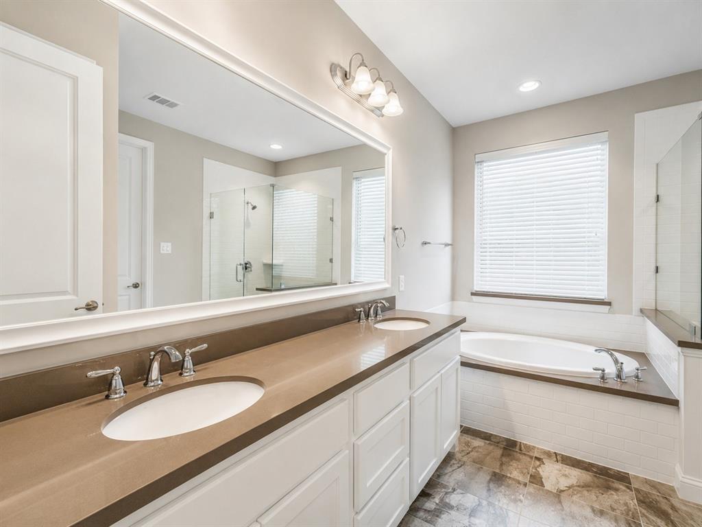 6209 Cupleaf Road Flower Mound, TX 76226 - Photo 17 of 29 Bathroom featuring a dual vanity with a brown countertop, white cabinetry, and undermount sinks