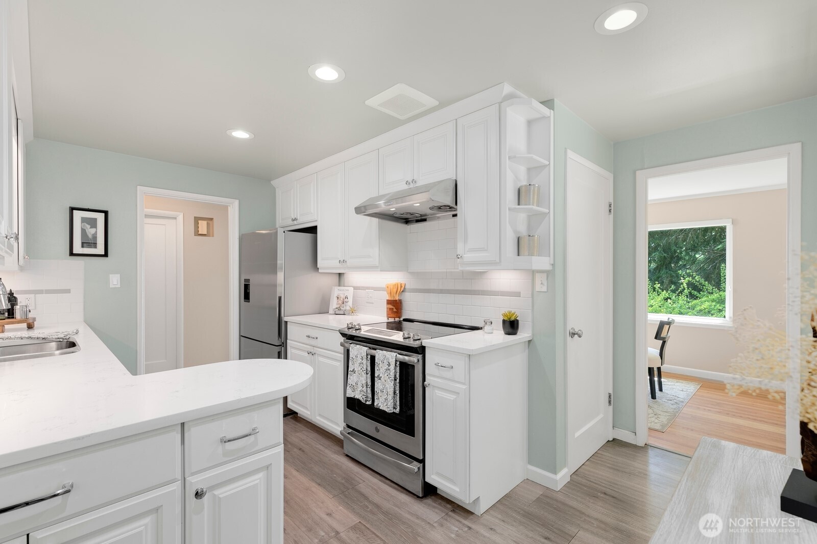 1429 Southwest 170th Street Normandy Park, WA 98166 - Photo 13 of 31 a kitchen with stainless steel appliances a stove and white cabinets