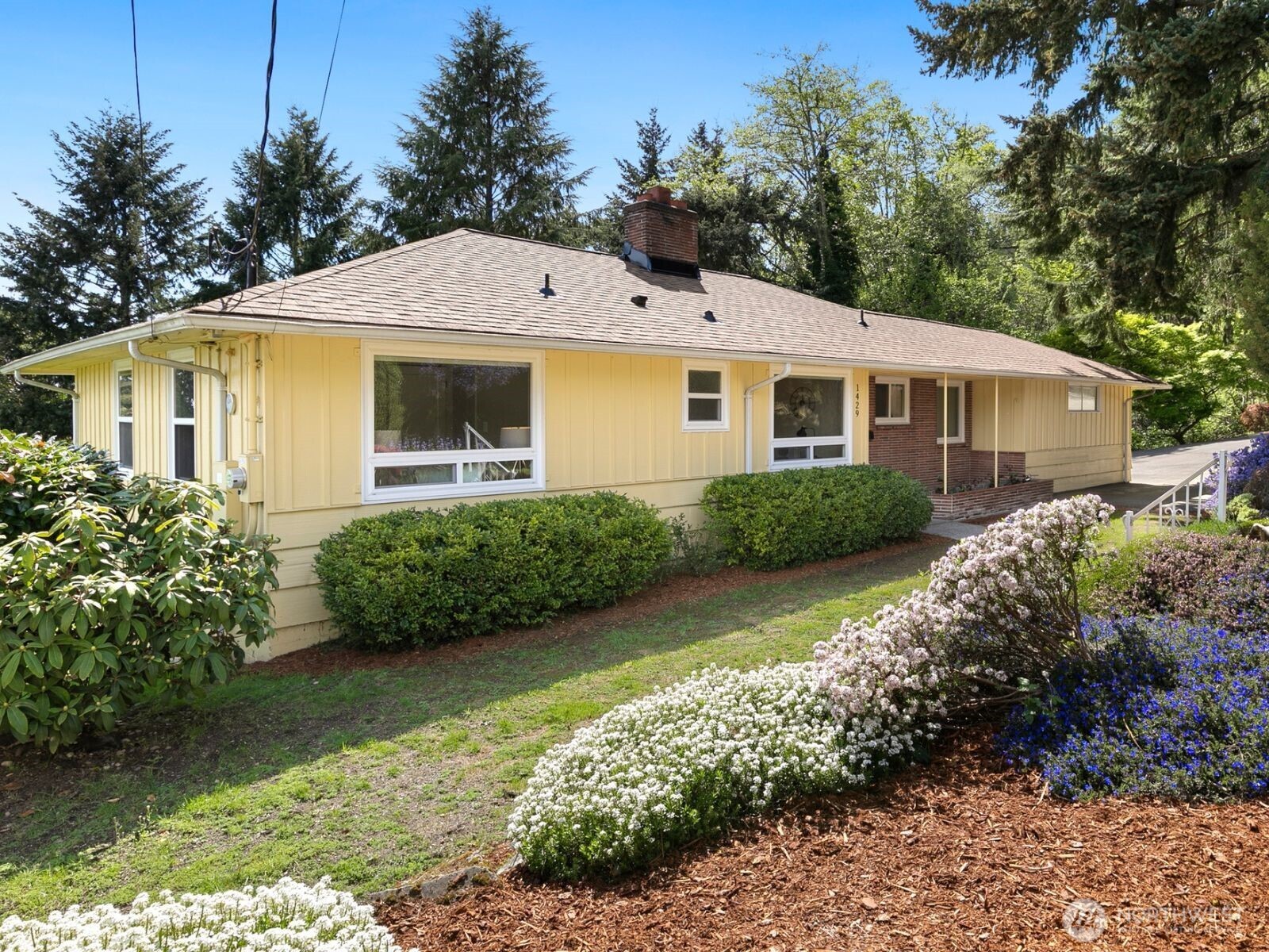 1429 Southwest 170th Street Normandy Park, WA 98166 - Photo 2 of 31 a front view of a house with garden