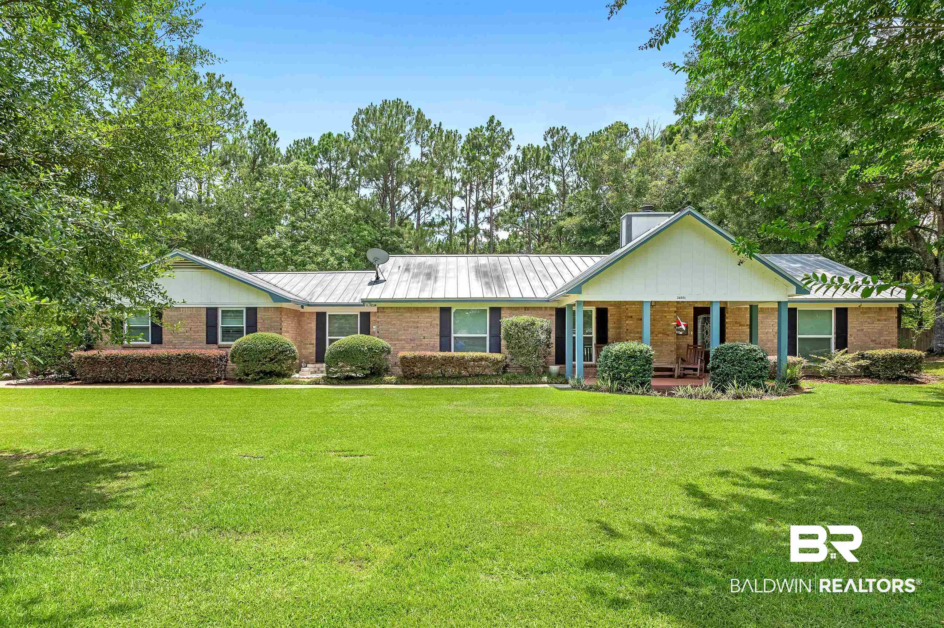 24551 Wolf Bay Drive Foley, AL 36535 - Photo 1 of 59 Ranch-style home with covered porch, a front lawn, and brick siding