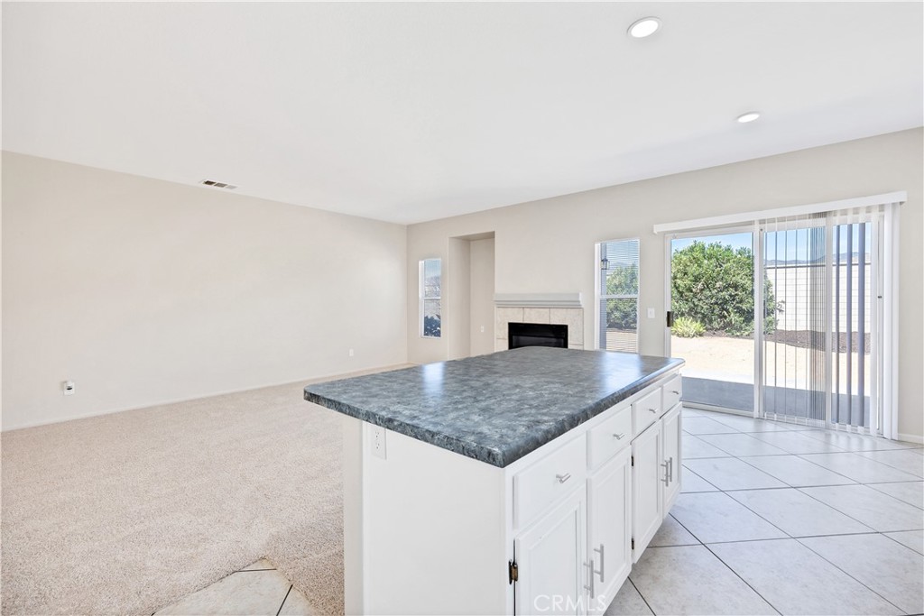 43850 Tiber Street Hemet, CA 92544 - Photo 19 of 39 a kitchen with granite countertop a sink and white cabinets