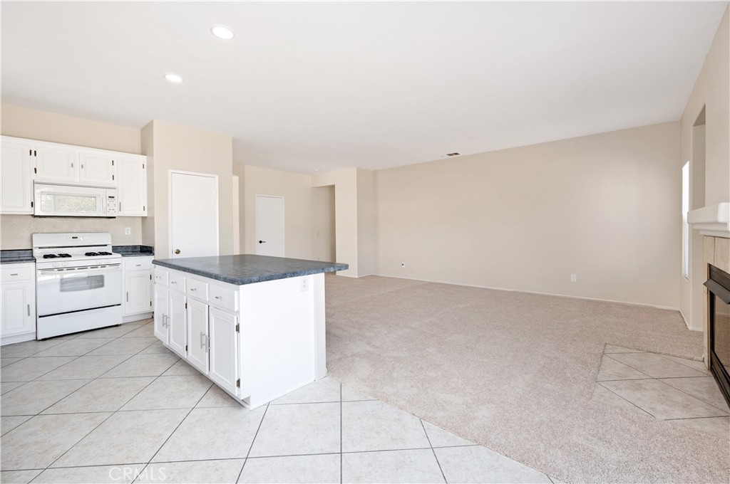 43850 Tiber Street Hemet, CA 92544 - Photo 21 of 39 a large kitchen with cabinets and white appliances