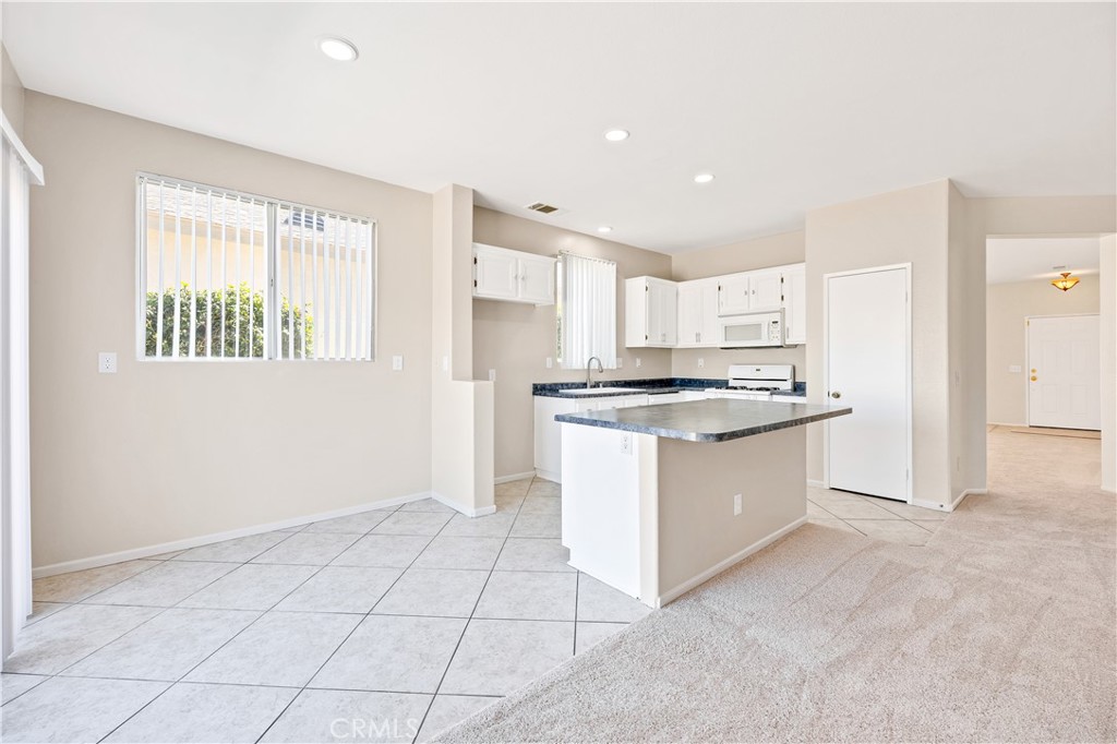 43850 Tiber Street Hemet, CA 92544 - Photo 22 of 39 a kitchen with granite countertop white cabinets and white appliances