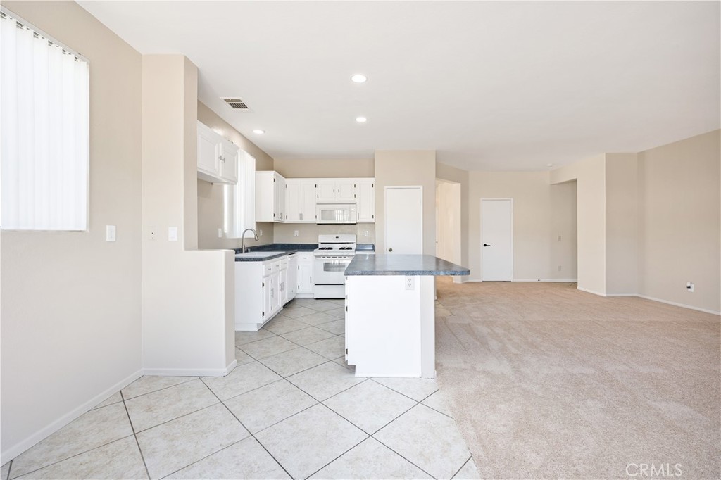 43850 Tiber Street Hemet, CA 92544 - Photo 23 of 39 a kitchen with white cabinets and white appliances