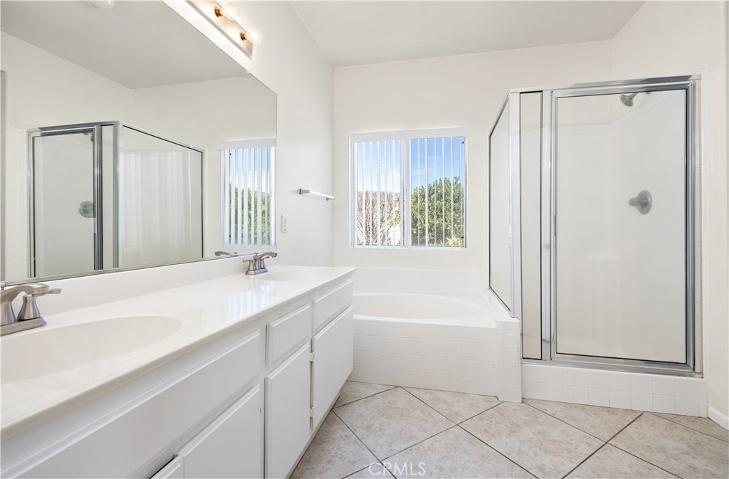 43850 Tiber Street Hemet, CA 92544 - Photo 27 of 39 a bathroom with a sink a mirror and a bathtub