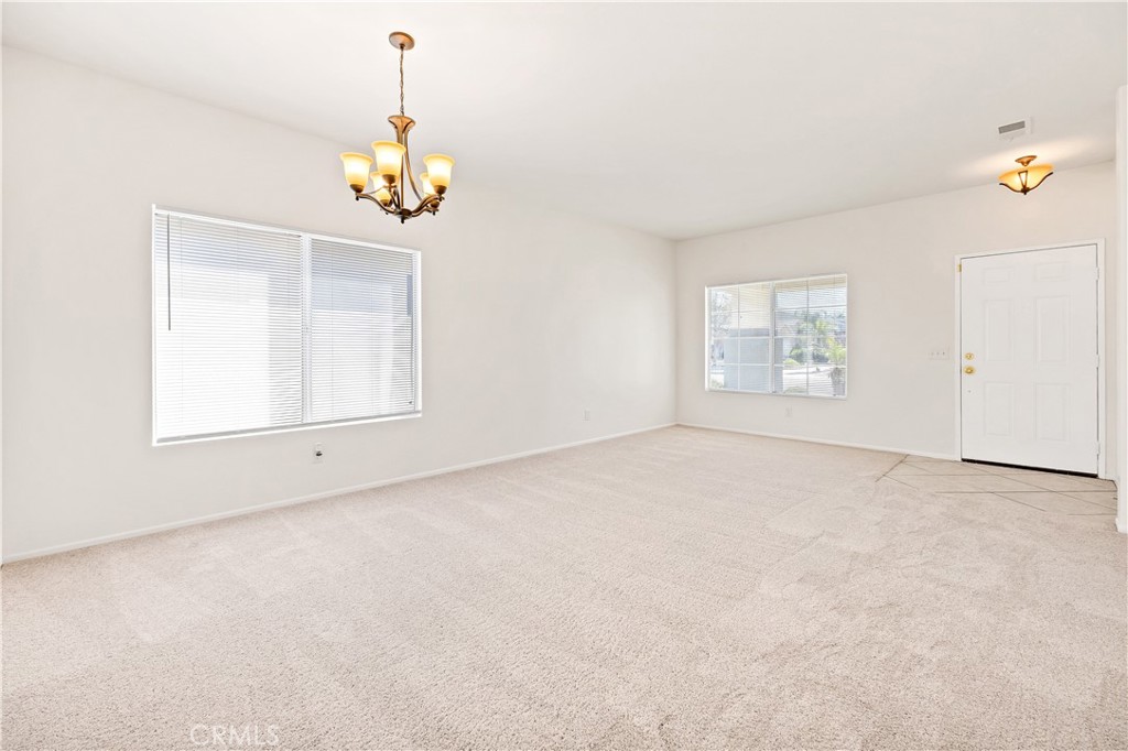 43850 Tiber Street Hemet, CA 92544 - Photo 8 of 39 an empty room with windows and cabinet