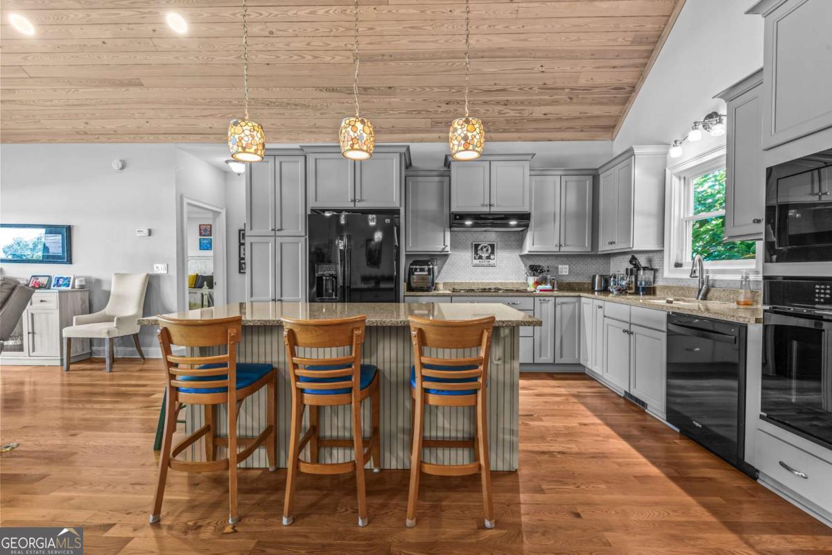 114 Sinclair Lane Eatonton, GA 31024 - Photo 12 of 76 a large kitchen with a table and chairs