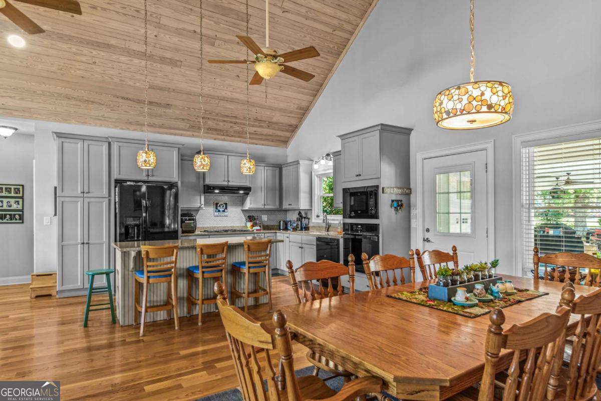 114 Sinclair Lane Eatonton, GA 31024 - Photo 16 of 76 a view of a dining room with furniture wooden floor and chandelier