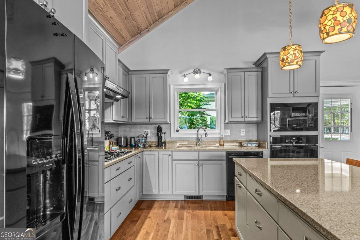 114 Sinclair Lane Eatonton, GA 31024 - Photo 17 of 76 a kitchen with stainless steel appliances granite countertop a sink stove and refrigerator