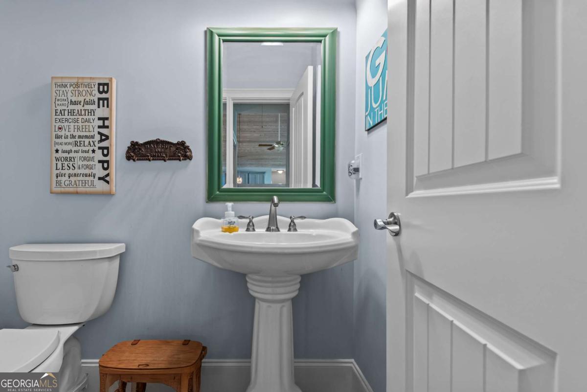 114 Sinclair Lane Eatonton, GA 31024 - Photo 27 of 76 a bathroom with a sink a toilet and mirror