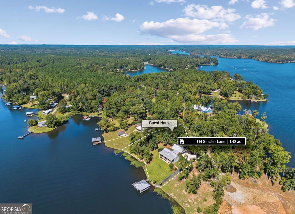 114 Sinclair Lane Eatonton, GA 31024 - Photo 3 of 76 a view of a lake with a mountain in the background