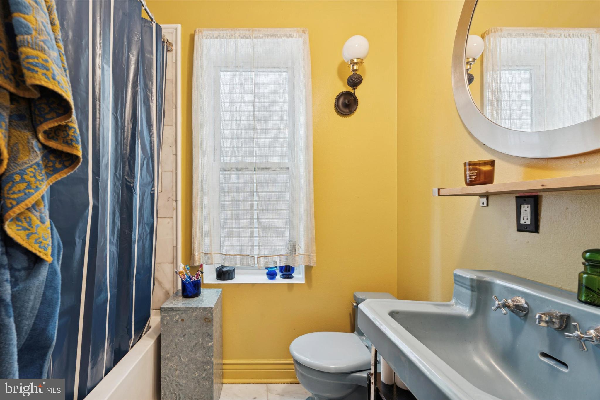 2540 Collins Street Philadelphia, PA 19125 - Photo 12 of 15 a bathroom with a toilet a sink and a mirror