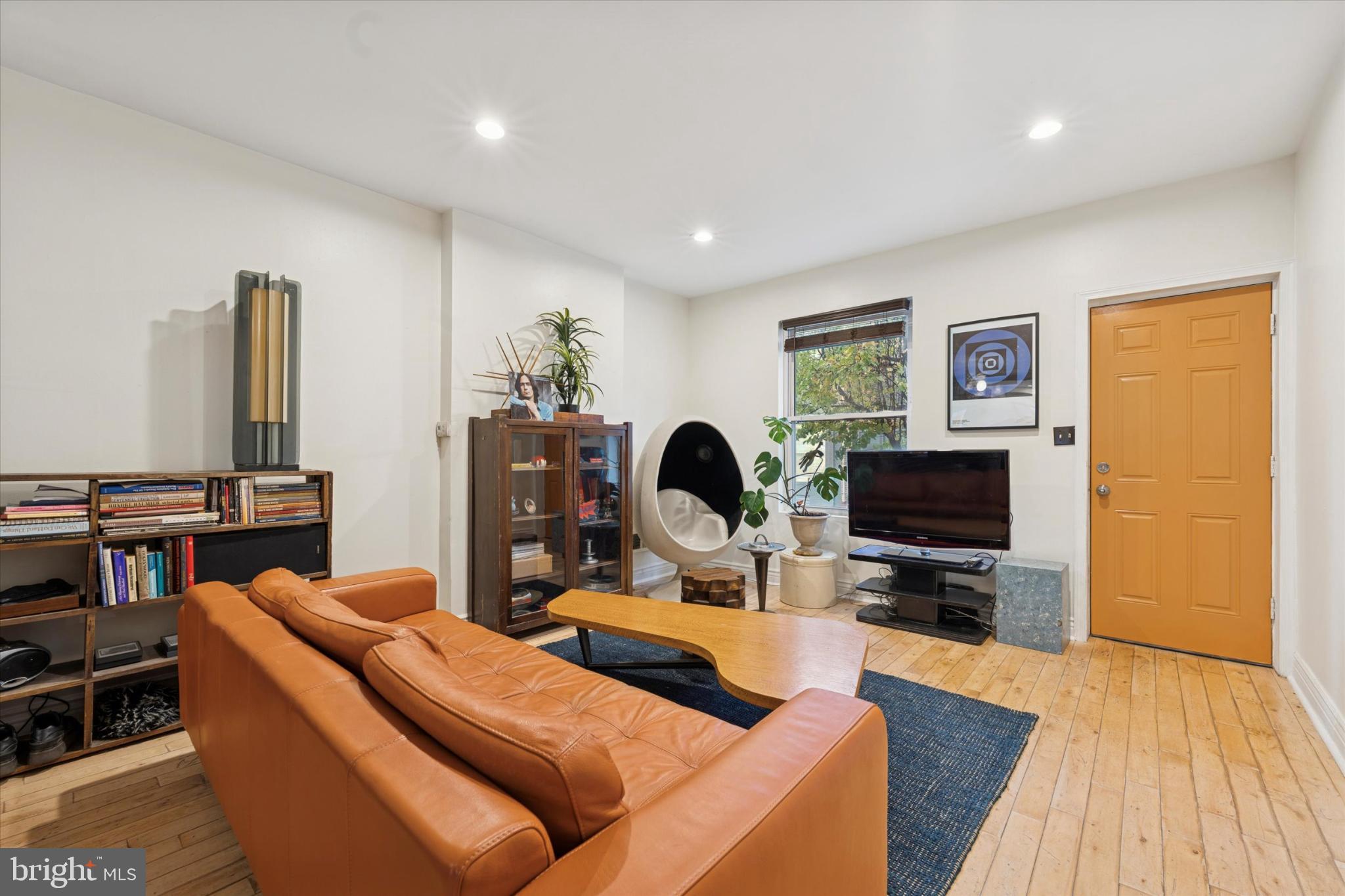 2540 Collins Street Philadelphia, PA 19125 - Photo 5 of 15 a living room with furniture a flat screen tv and a fireplace