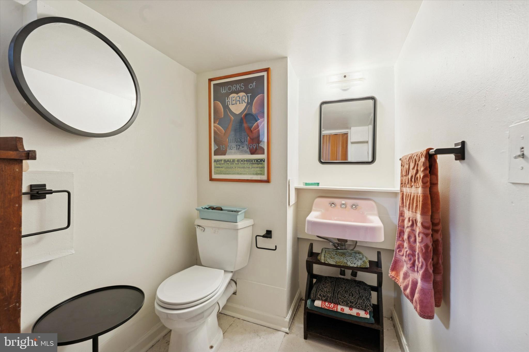 2540 Collins Street Philadelphia, PA 19125 - Photo 9 of 15 a bathroom with a toilet a sink and a mirror