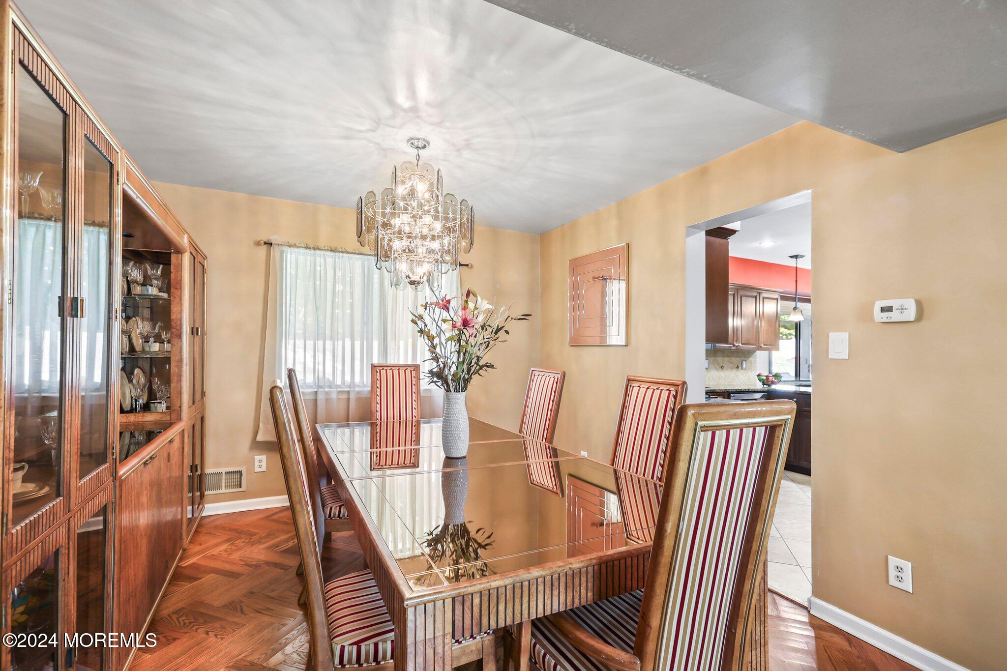 14 Cherry Bend Drive Howell, NJ 07731 - Photo 12 of 47 a view of a dining room with furniture wooden floor and chandelier