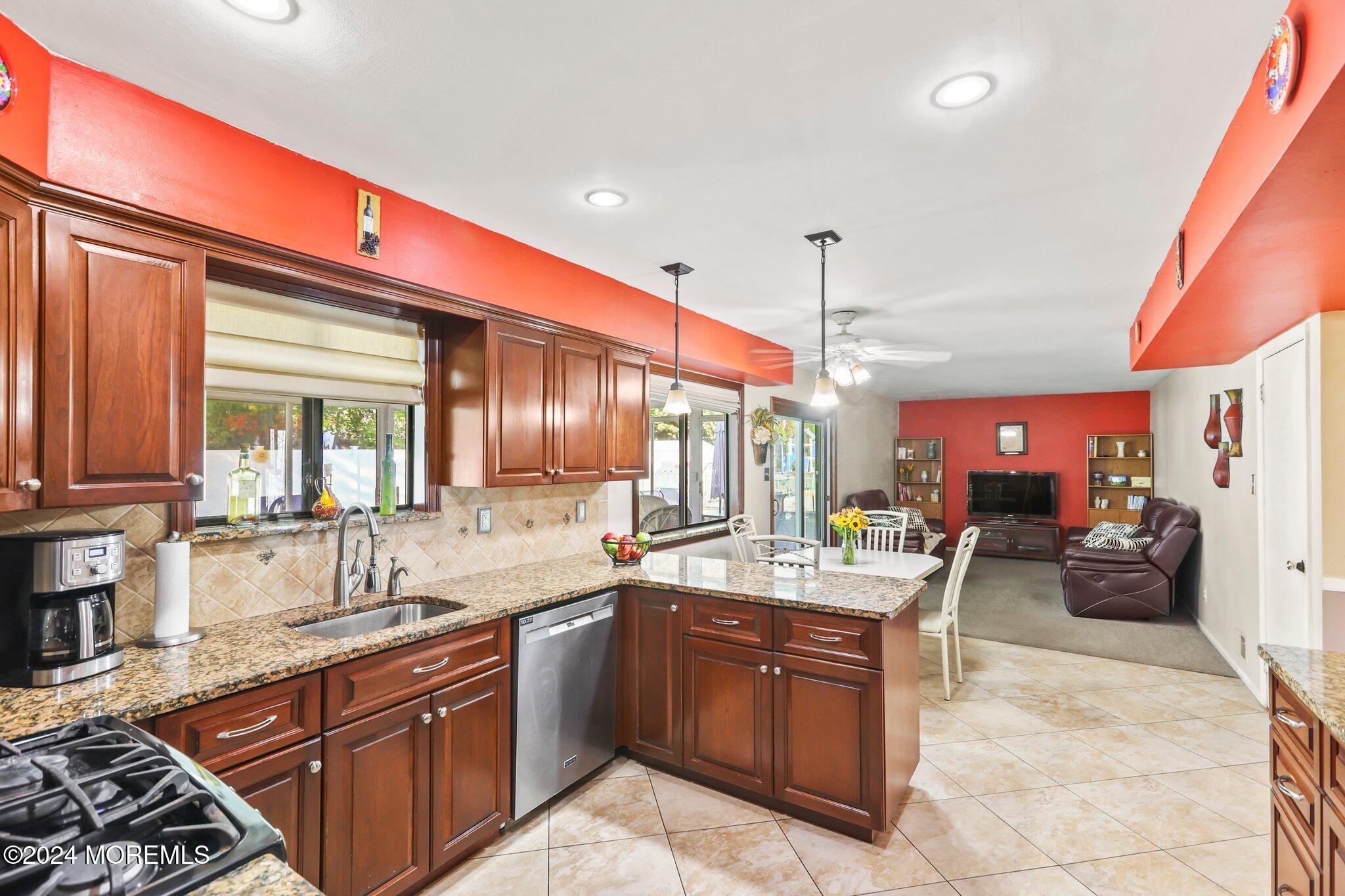 14 Cherry Bend Drive Howell, NJ 07731 - Photo 13 of 47 a kitchen with stainless steel appliances granite countertop a sink counter space cabinets and a window