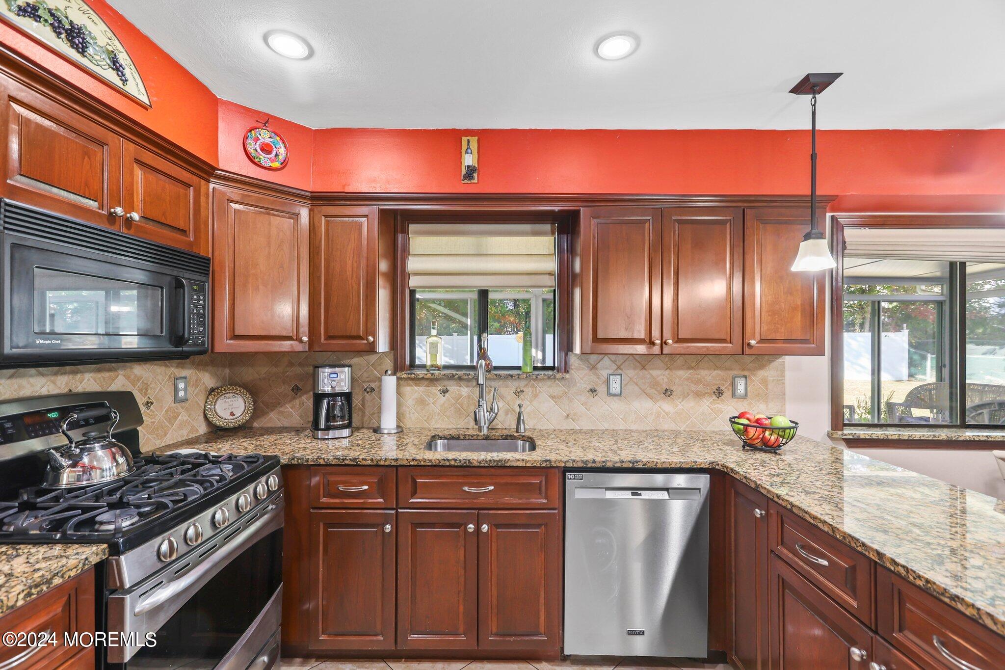 14 Cherry Bend Drive Howell, NJ 07731 - Photo 14 of 47 a kitchen with granite countertop a sink stove and cabinets