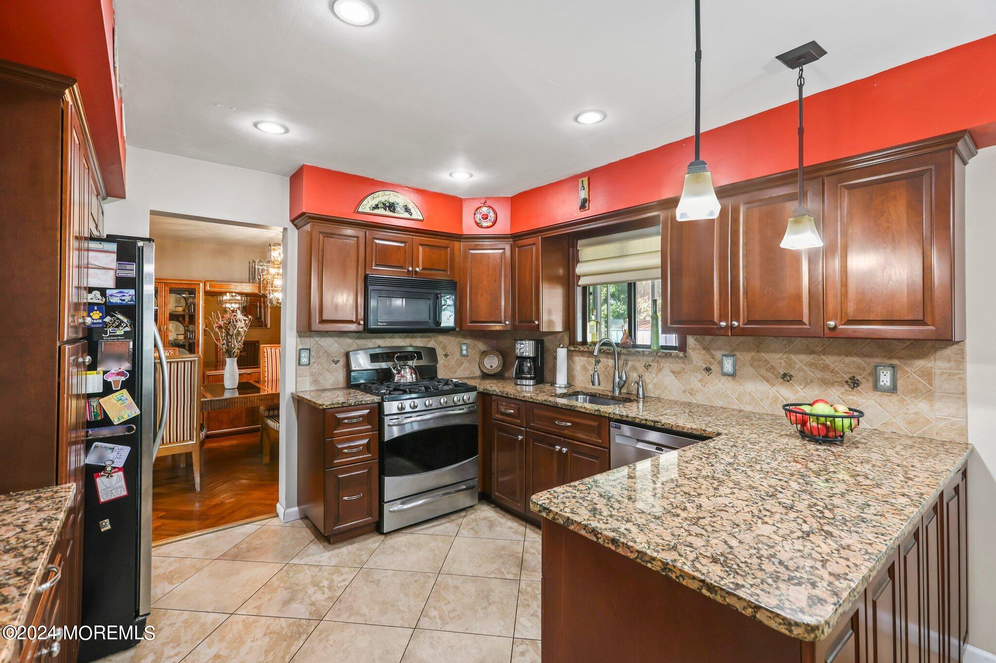 14 Cherry Bend Drive Howell, NJ 07731 - Photo 15 of 47 a kitchen with stainless steel appliances granite countertop a sink stove and refrigerator