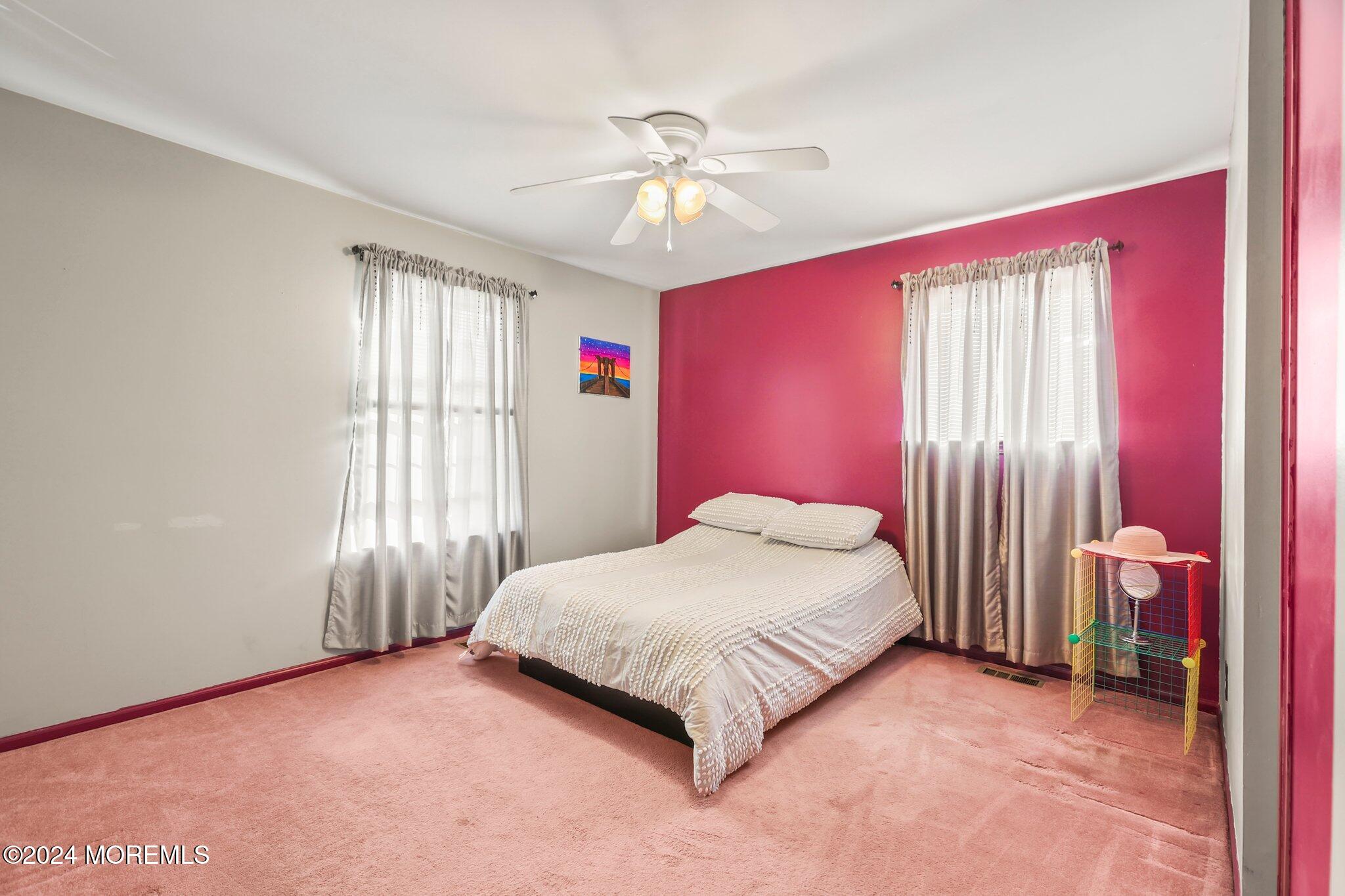 14 Cherry Bend Drive Howell, NJ 07731 - Photo 34 of 47 a bedroom with a bed and a chandelier