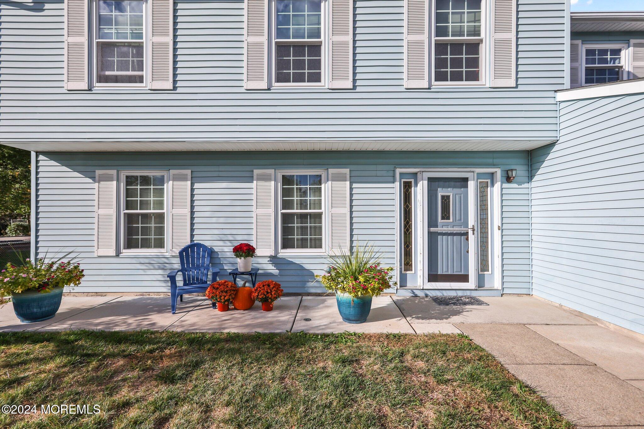 14 Cherry Bend Drive Howell, NJ 07731 - Photo 6 of 47 a front view of a house with chair and flowers