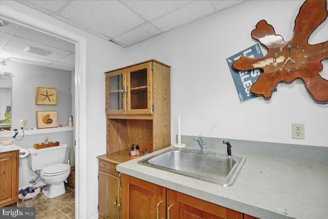 a bathroom with a sink mirror vanity and toilet