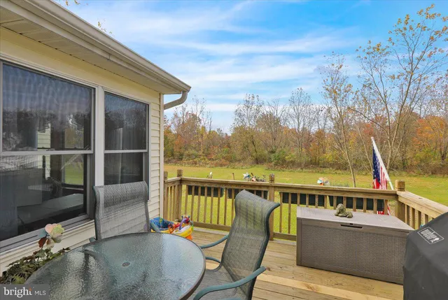 a view of a chairs and table in the balcony