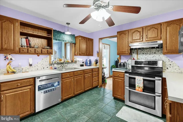a kitchen with stainless steel appliances granite countertop a stove and cabinets